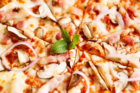 Fresh Italian pizza with mushrooms and bacon in a box, closeup.の写真素材
