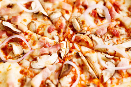 Fresh Italian pizza with mushrooms and bacon in a box, closeup.の写真素材