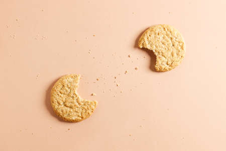 Oatmeal cookie on orange color background. Healthy round cookies. Top view.の写真素材
