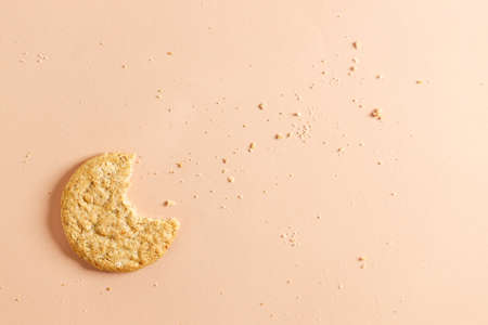 Oatmeal cookie on orange color background. Healthy round cookies. Top view.の写真素材