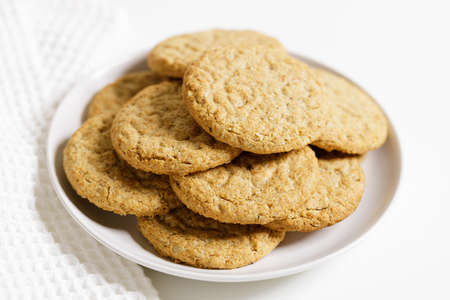 Oatmeal cookies on white plate. Healthy round cookies.の写真素材