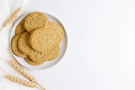 Oatmeal cookies on white plate. Healthy round cookies. Top view.の写真素材