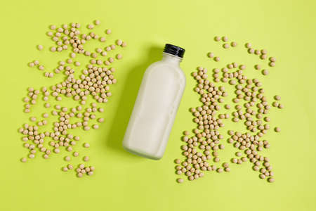 soy milk on green background. Healthy vegan alternative substitute milk. Bottle of soy milk.の写真素材