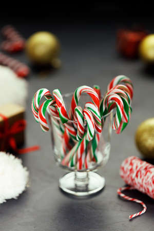 candy canes with red, green and white color in a glass on dark background.の写真素材