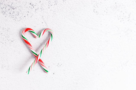 candy canes with red, green and white color on white marble background. Top view.の写真素材