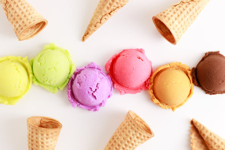 variety of ice cream scoops on white background with waffle cones, top view.の写真素材