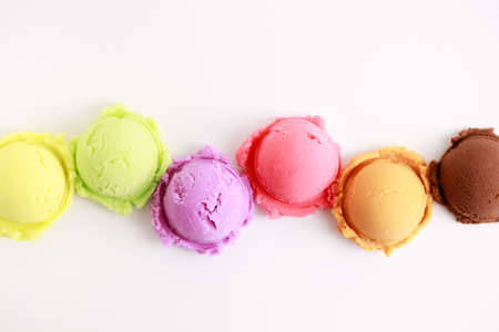 variety of ice cream scoops on white background, top view.