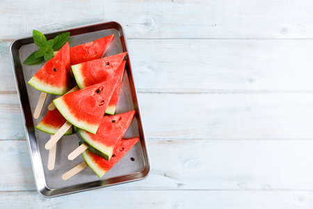 watermelon slice on light blue wooden background. top view.の写真素材