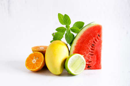 variety of summer fruits, watermelon mango lime orange, Flat lay on light marble background. Summer food concept.の写真素材