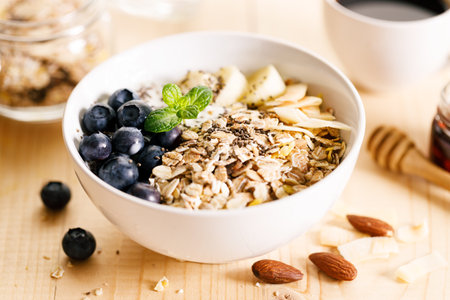 Healthy breakfast with yogurt, granola and fresh blueberries in a bowl on wooden table. Healthy eating and dieting concept.の写真素材
