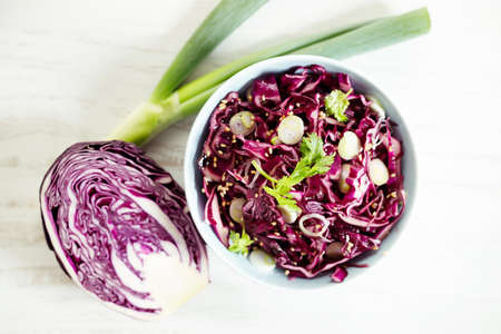 red cabbage salad, coleslaw, in a bowl on white wooden table. closeup.の写真素材