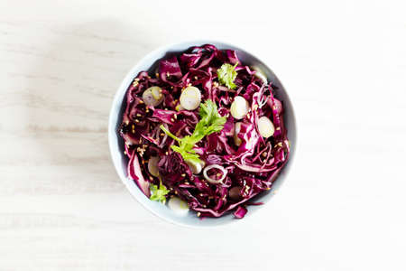 red cabbage salad, coleslaw, in a bowl on white wooden table. closeup.の写真素材