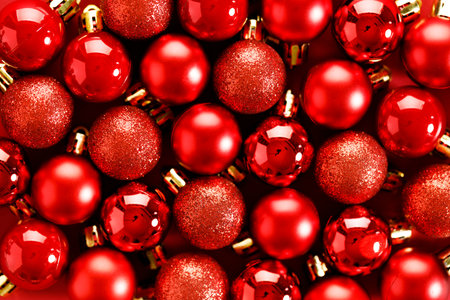 New year background with red ornament decorations on red background. Christmas and New Year background top view.の写真素材