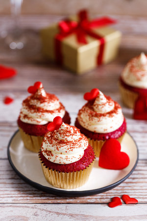 Small cupcakes with red hearts on wooden background. Valentineâs day and sweet pastries concept.の写真素材