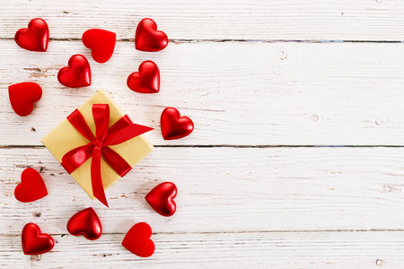 Valentineâs day. Present and red hearts on wooden background. Top view with copy space.の写真素材