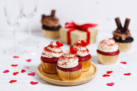 Small cupcakes with red hearts on wooden background. Valentineâs day and sweet pastries concept.の写真素材