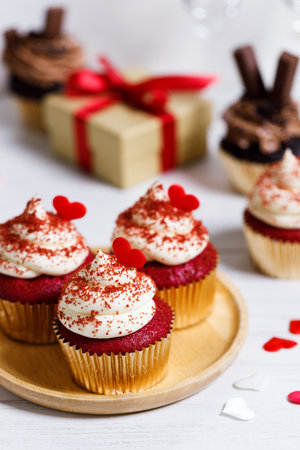 Small cupcakes with red hearts on wooden background. Valentineâs day and sweet pastries concept.の写真素材