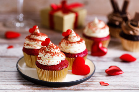 Small cupcakes with red hearts on wooden background. Valentineâs day and sweet pastries concept.の写真素材