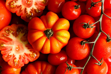 Top view of various fresh red tomatoes background. Closeup.の写真素材