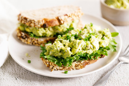 Wholegrain toasted bread with avocado and boiled egg smash. Top view. Healthy diet breakfast.の写真素材