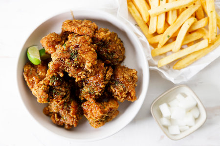 Fried chicken with soy sauce in Korean style with pickled radish. Closeup.の写真素材
