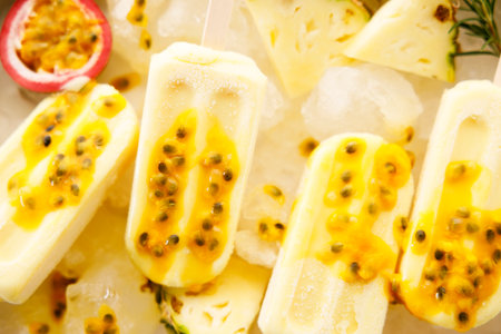 Homemade ice cream popsicles from pineapple topped with passion fruit. Summer sweets.の写真素材