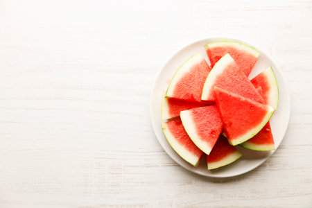 Fresh sliced watermelon on white wooden table background. Summer sweet eating concept.の写真素材