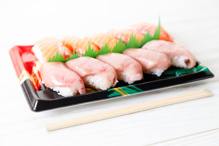 Sushi set with tuna and salmon. Fresh made Sushi on a plastic tray. Traditional Japanese cuisine.の写真素材