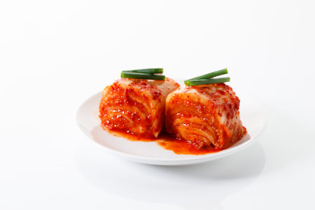 Kimchi cabbage. Korean traditional cabbage kimchi, fermented cabbages, in a white plate. Closeup.の写真素材