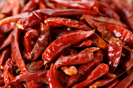 Dried red hot chili peppers on wooden tray. Closeup.の写真素材