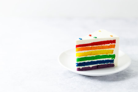 Piece of cake with rainbow colored. Closeup. Pride month concept. Rainbow love concept.