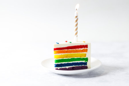 Piece of cake with rainbow colored. Closeup. Pride month concept. Rainbow love concept.の写真素材