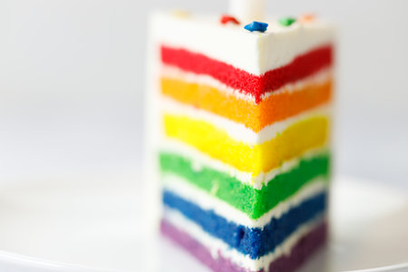 Piece of cake with rainbow colored. Closeup. Pride month concept. Rainbow love concept.の写真素材