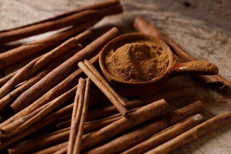 Cinnamon sticks and cinnamon powder on dark rustic background. Closeup.の写真素材