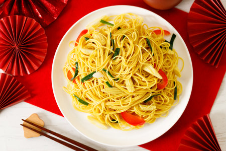 Longevity noodles with vegetables for Chinese Lunar New Year lucky food on wooden table background.の写真素材