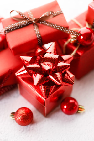 Assorted red gift box tied with bows on white background. Christmas decorations and red balls on white background. Christmas New year concept.の写真素材