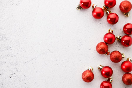 New year background with red ornament decorations on white marble background. Christmas and New Year background. top view.の写真素材