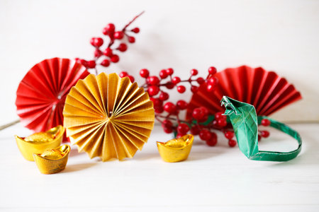 Chinese new year festival background with red Chinese folded fans on white wooden table. Abstract art with folding paper fans. Celebrate Lunar new year background concept. 
All Brushscript Texts in Chinese meaning luck.の写真素材