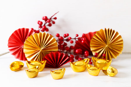 Chinese new year festival background with red Chinese folded fans on white wooden table. Abstract art with folding paper fans. Celebrate Lunar new year background concept.の写真素材