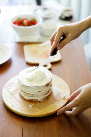 Homemade strawberry shortcake topped with fresh strawberries. On making process homemade strawberry shortcake. Closeup.の写真素材