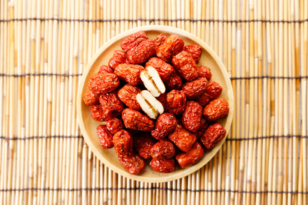 Dried jujube or Dried red Chinese dates, seedless on wooden background. Closeup.の写真素材