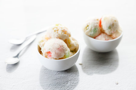 yogurt and jelly ice cream in a white bowl. Small bowls of yogurt and jelly ice cream flavor on white marble table. Closeup.の写真素材