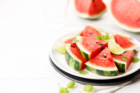 Grilled watermelon with lime and mint leaves. Sliced watermelon salad with lime juice. Summer dish. Closeup.の写真素材