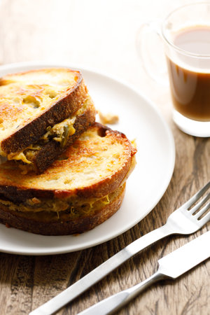 Crispy grilled cheese and tuna sandwiches sourdough bread on white plate.の写真素材