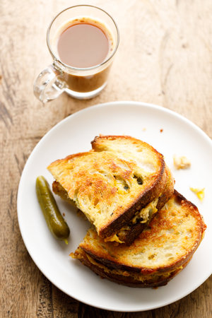 Crispy grilled cheese and tuna sandwiches sourdough bread on white plate.の写真素材
