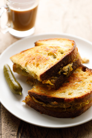 Crispy grilled cheese and tuna sandwiches sourdough bread on white plate.の写真素材