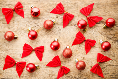 Red ribbons on wooden background. Christmas decorations concept. Top view.の写真素材
