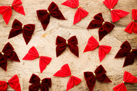 Red ribbons on wooden background. Christmas decorations concept. Top view.の写真素材
