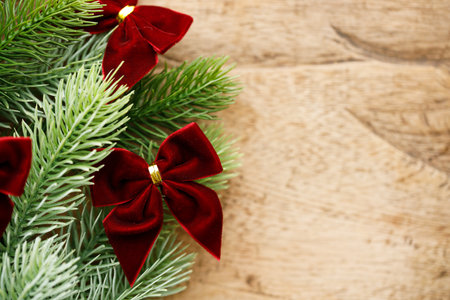 Red ribbons with pine branches, Christmas tree concept. Closeup.の写真素材