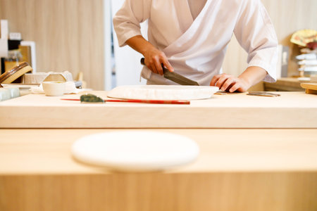 Japanese sushi restaurant with sushi chef preparing Sushi behind the counter of Restaurant.の写真素材